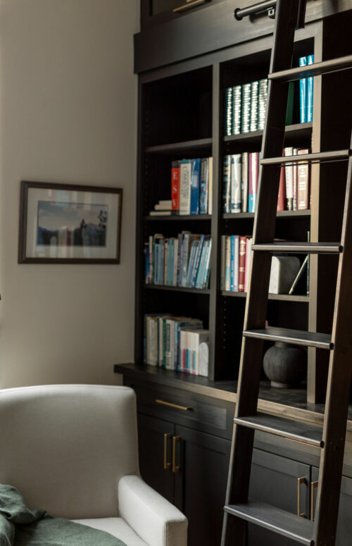 Ladder next to modern cabinet set with books as design decoration